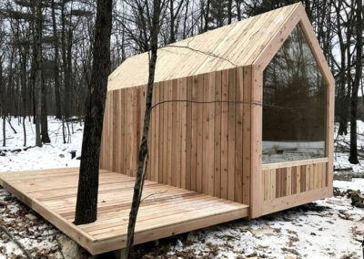 A - Cabin with vertical weatherboard roof and cladding